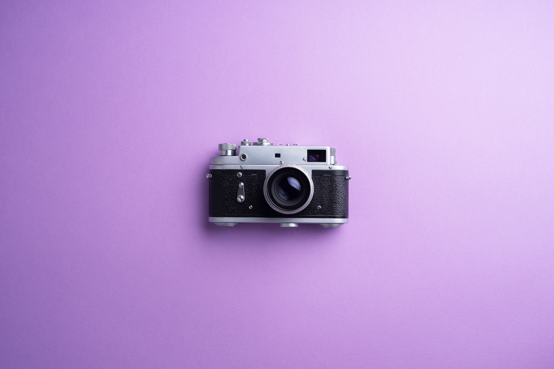 Vintage camera over purple background